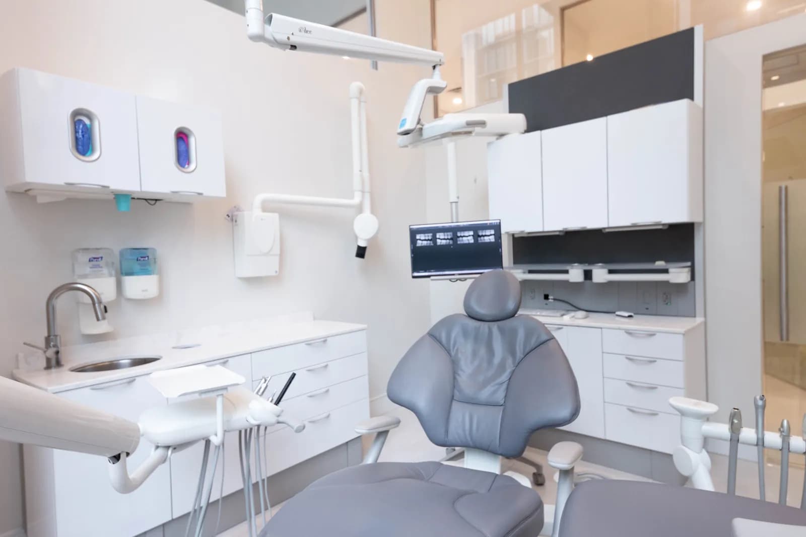 Modern dental treatment room with a digital X-ray screen at Dentistry on Gloucester